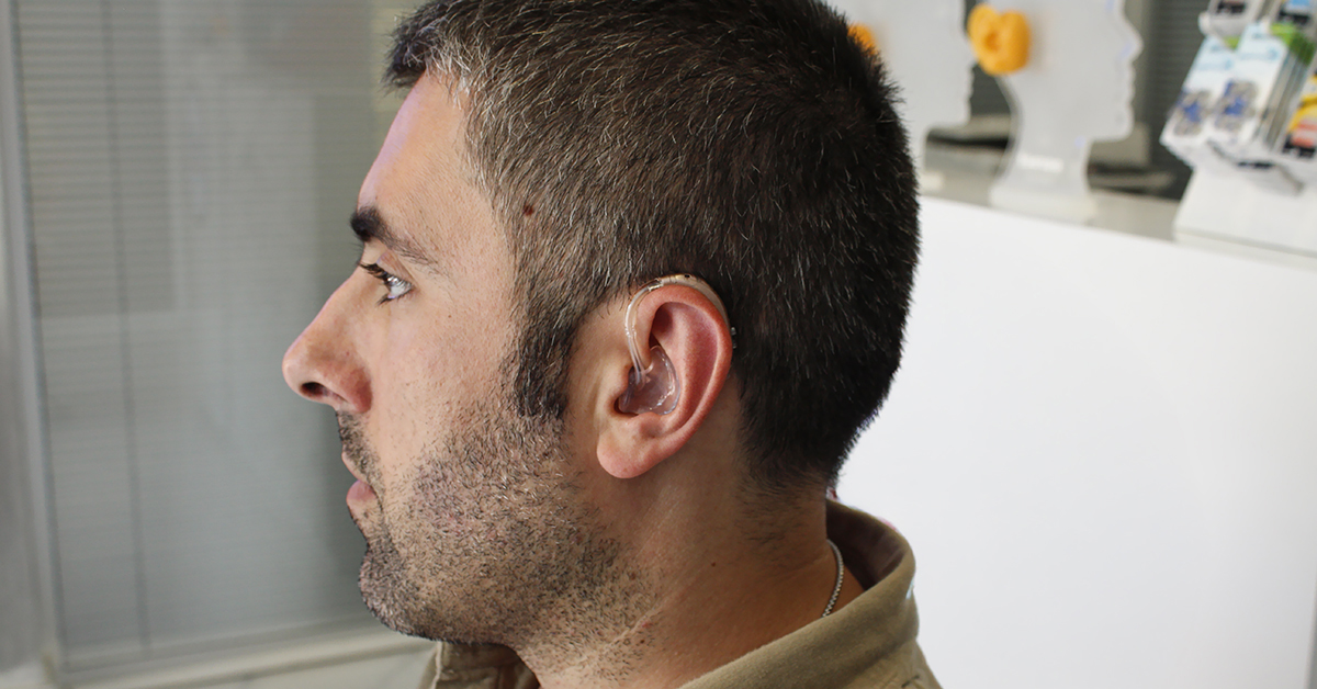 Man wearing a behind-the-ear hearing aid