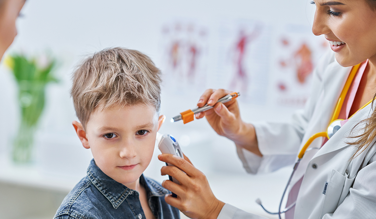 Child receiving an ear and hearing examination