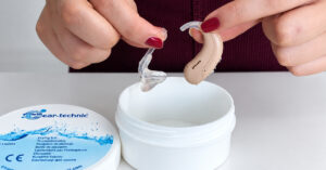 Hearing aid care and drying container