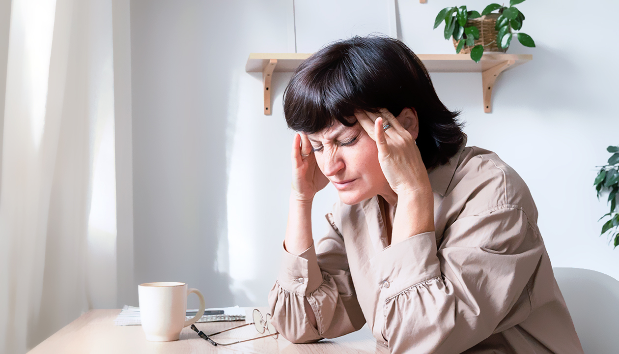 Woman experiencing tinnitus and ear ringing